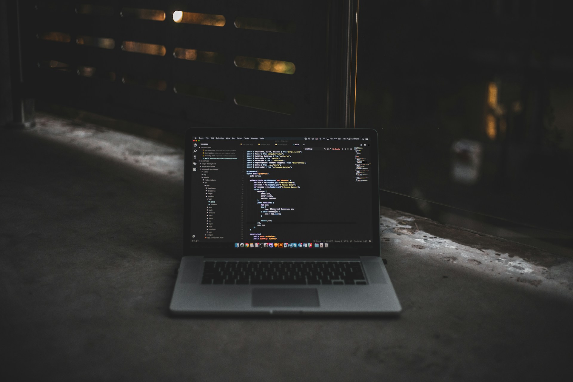 Laptop and coding in black theme